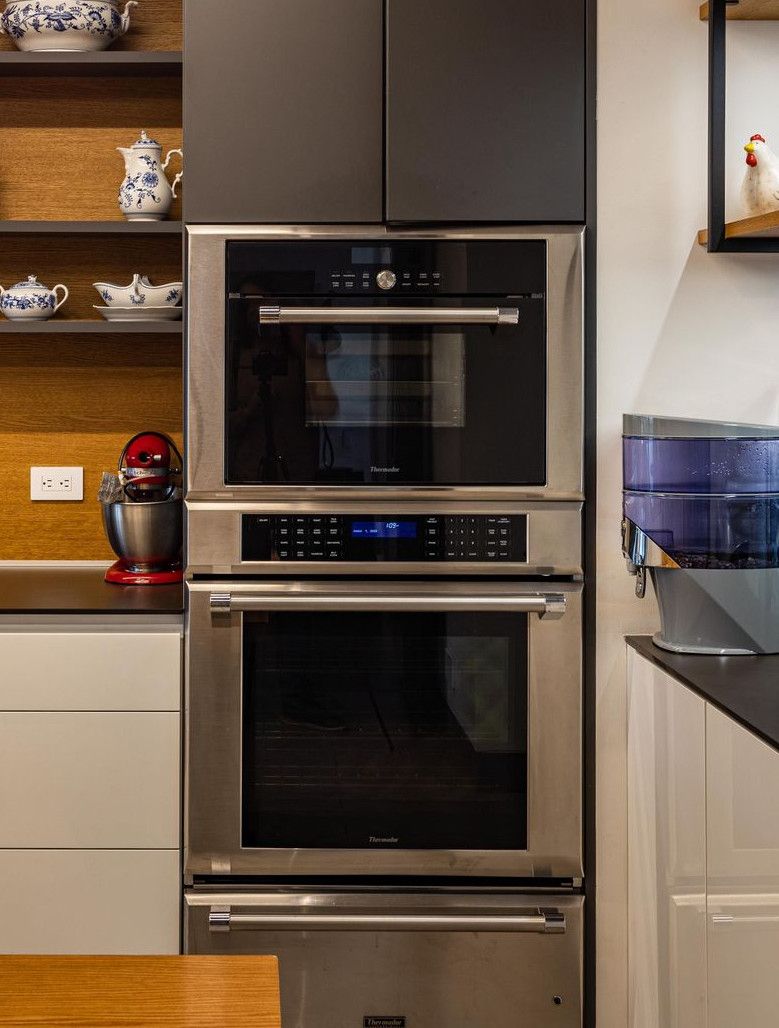 Contemporary kitchen design featuring sleek cabinets, dual ovens, and chic decor.